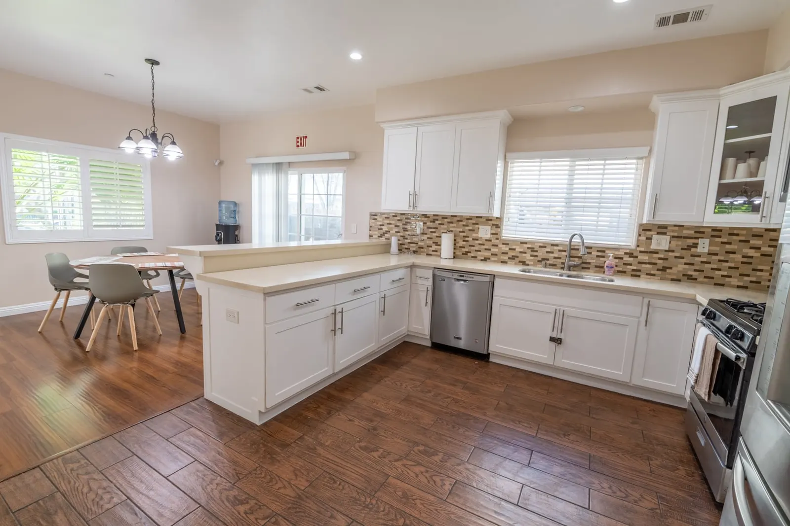 Shared kitchen with breakfast bar, dishwasher, and gas range