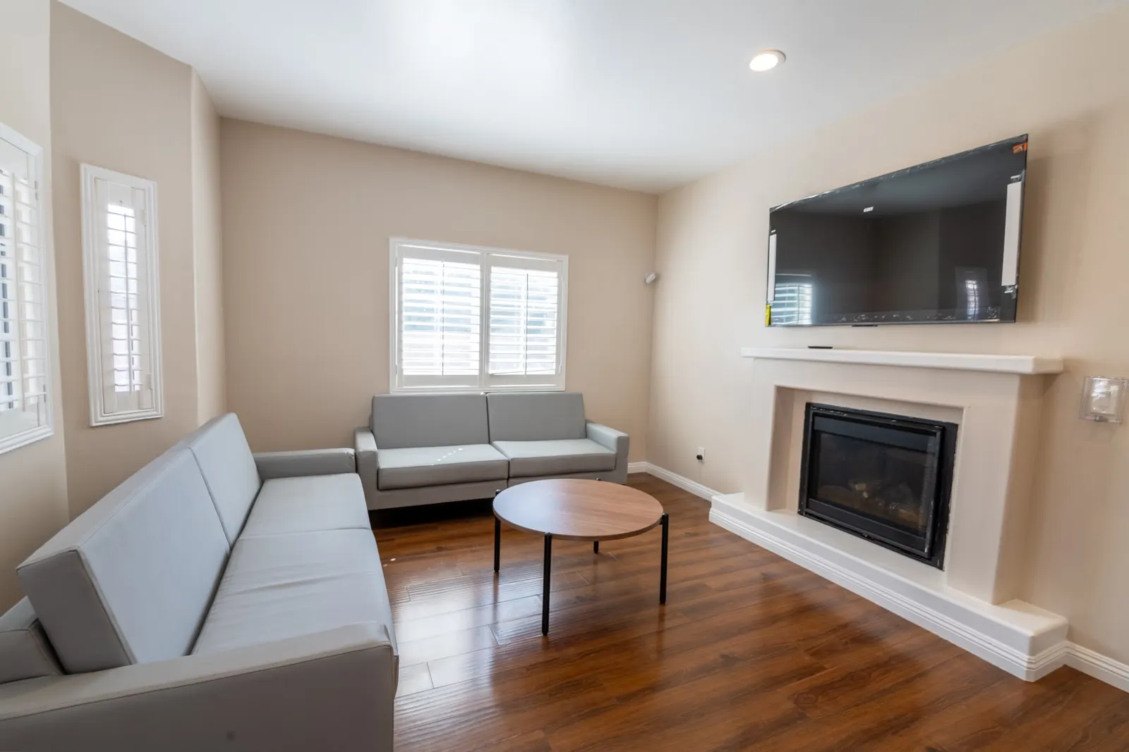 The same living room from the opposite corner, with sofas around a low table