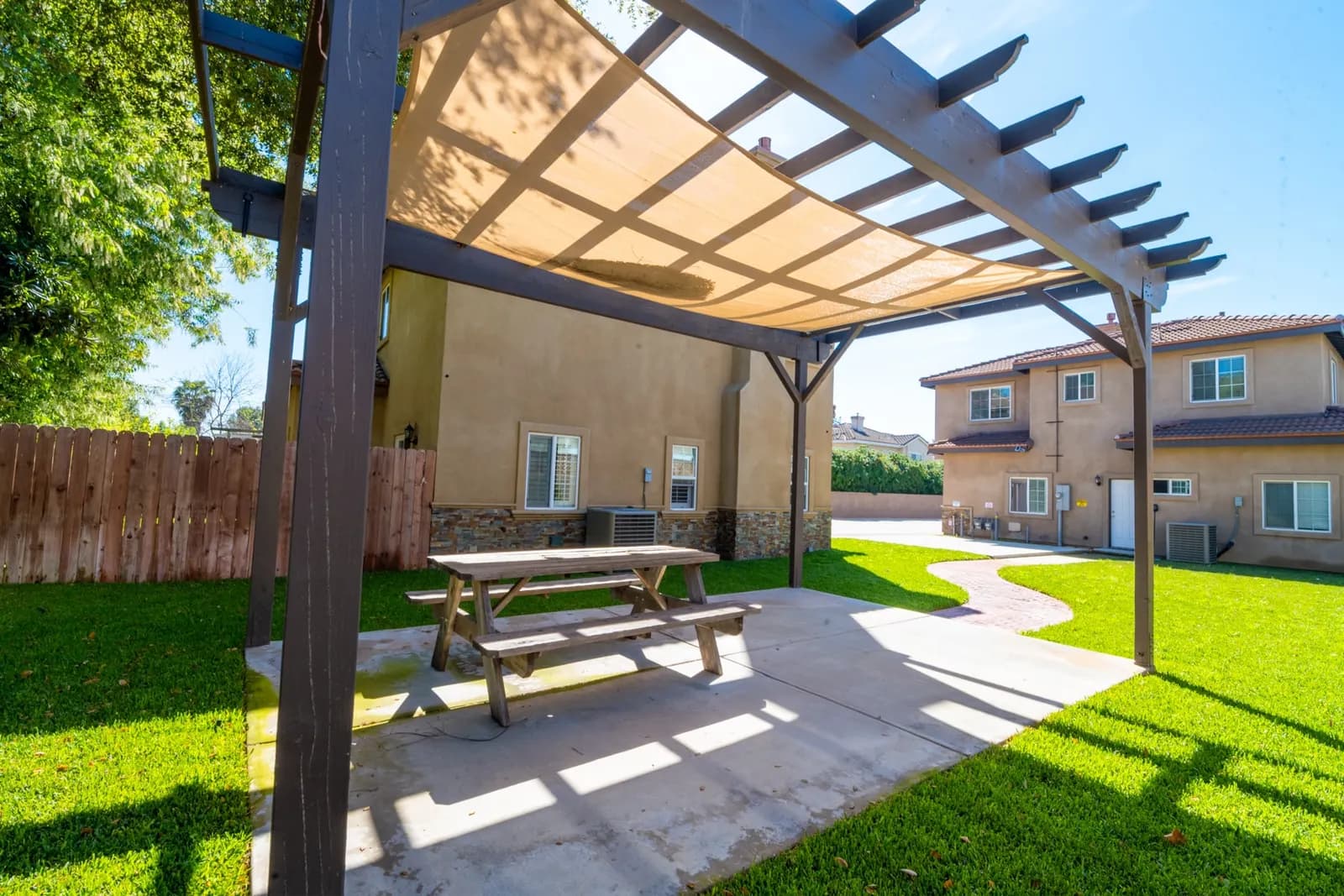 Shaded pergola and picnic table on the back lawn